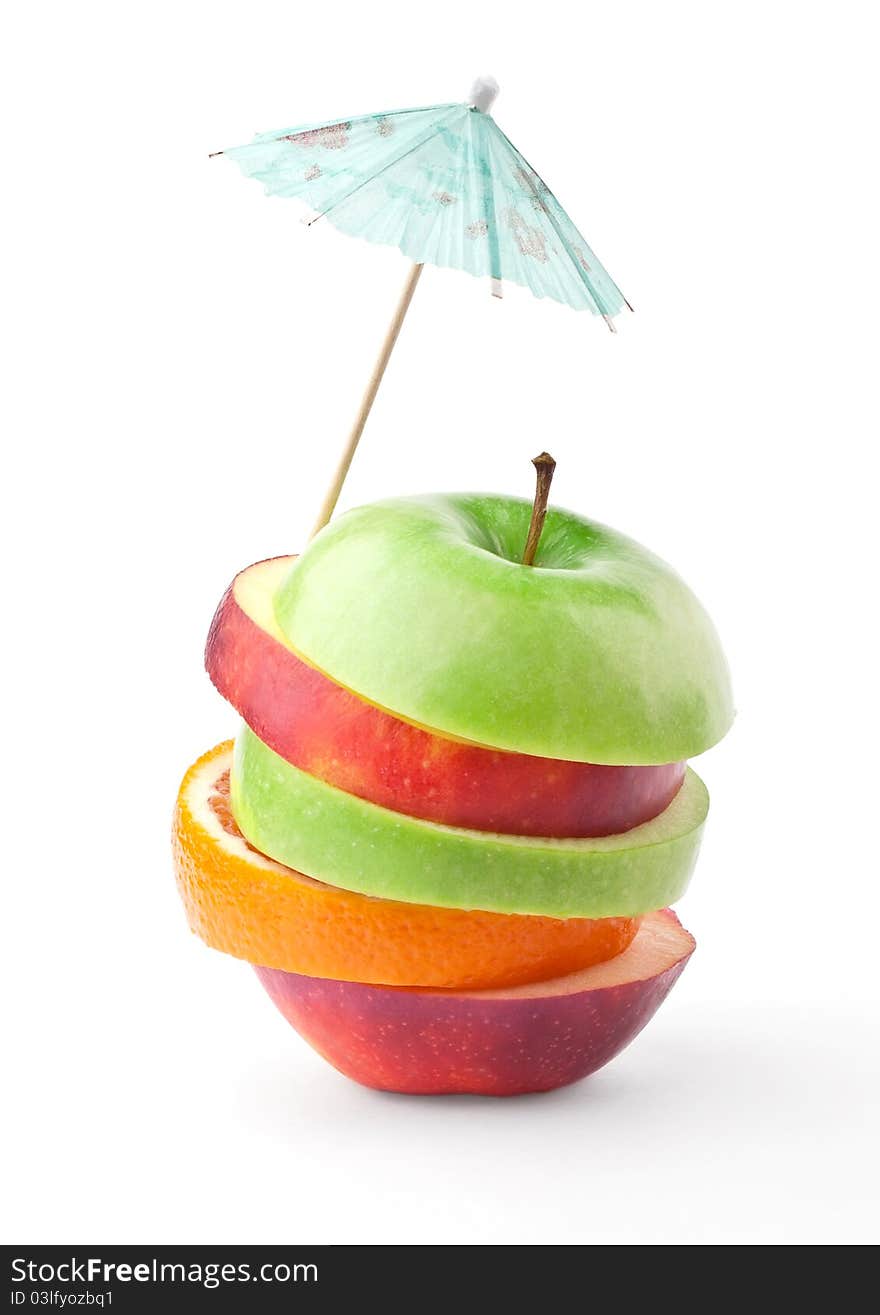 Layers of apples and oranges under umbrella isolated on white background