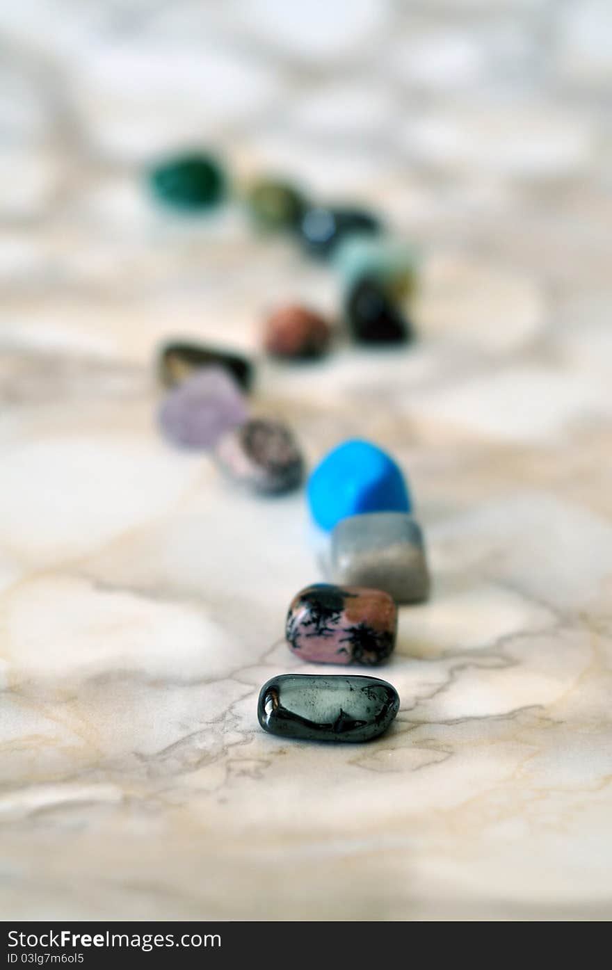 Small polished colorful stones in a row. Small polished colorful stones in a row