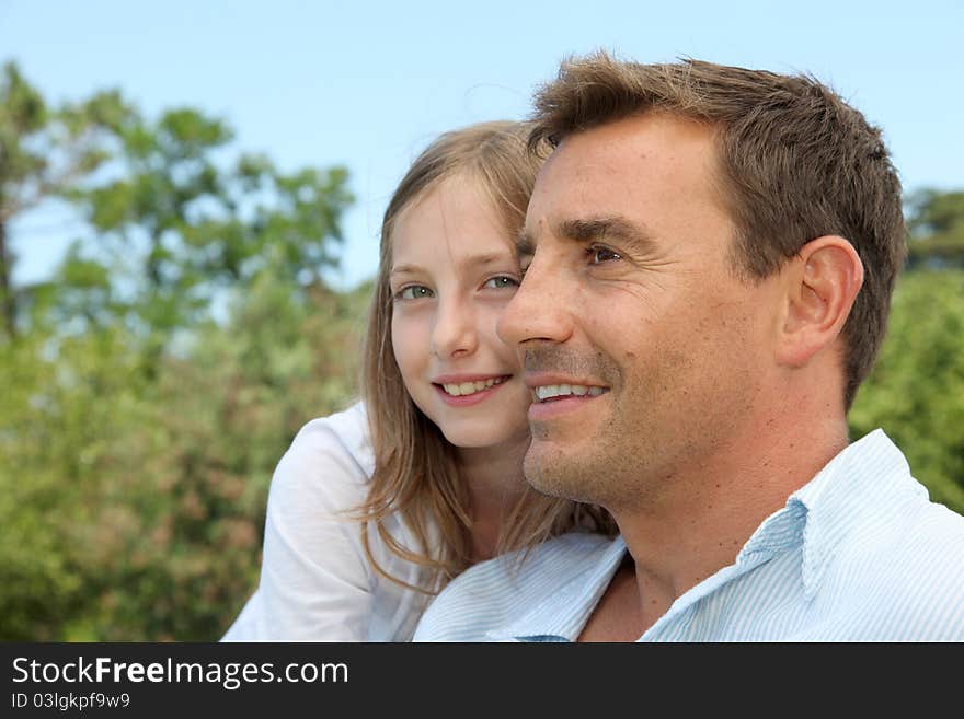 Father and daughter sitting in park. Father and daughter sitting in park