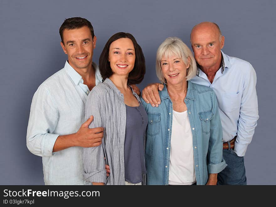 Family of four people standing on grey background. Family of four people standing on grey background