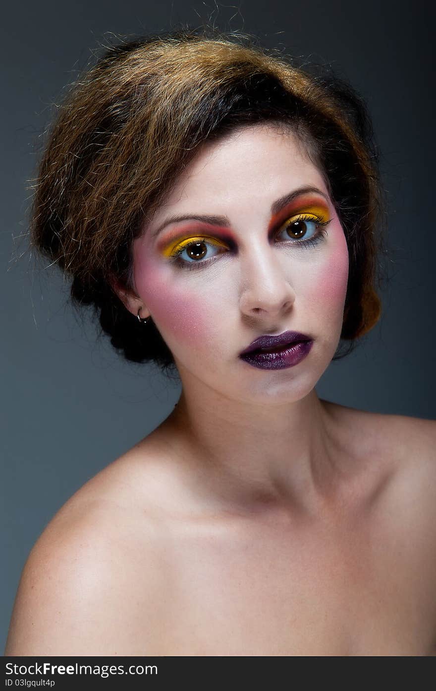 Female against grey with colourful make up