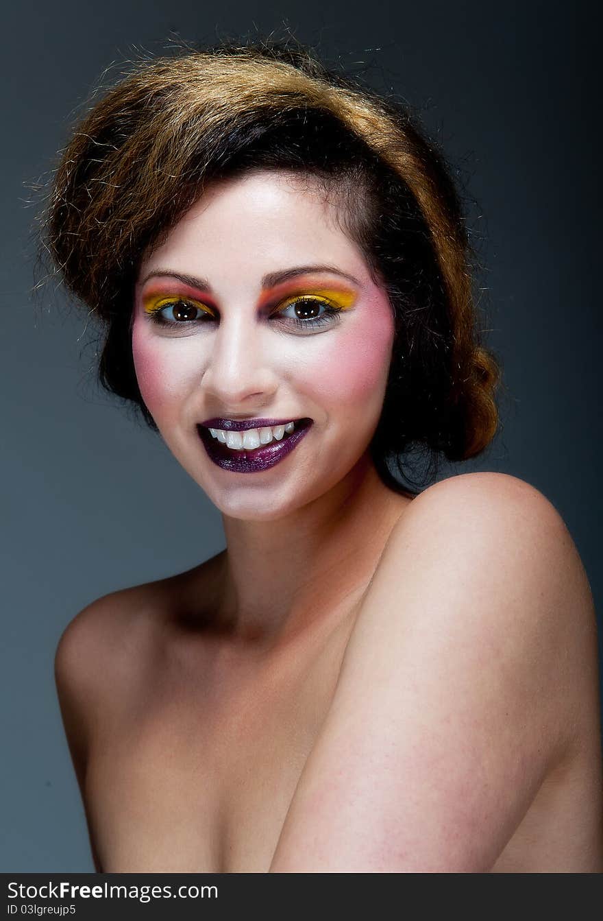 Female against grey with colourful make up