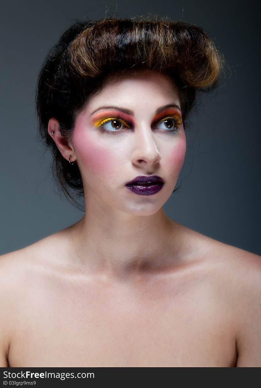 Female Against Grey With Colourful Make Up