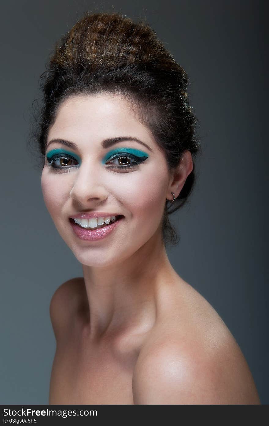 Beautiful young female against Grey with colourful make up