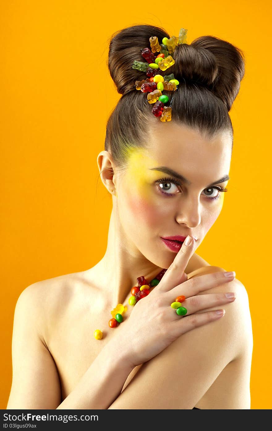 Close-up portrait of beautiful brunette with glamor make-up and color candy style