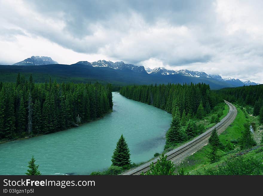 A rail track runs along a mighty river in Banff National Park. A rail track runs along a mighty river in Banff National Park.