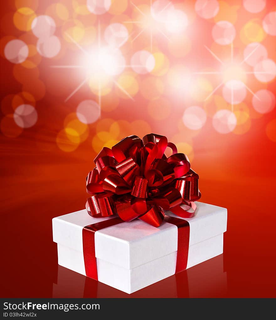 Gift in box with red ribbon