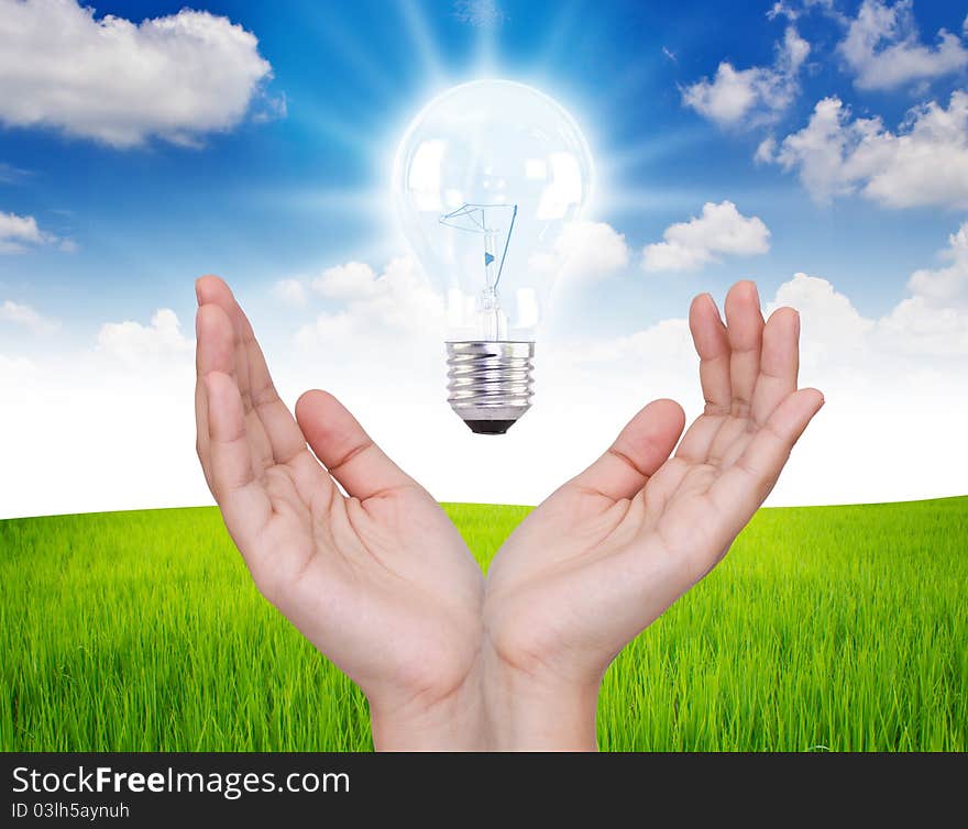 Business hand with Light bulb over blue sky. Business hand with Light bulb over blue sky.