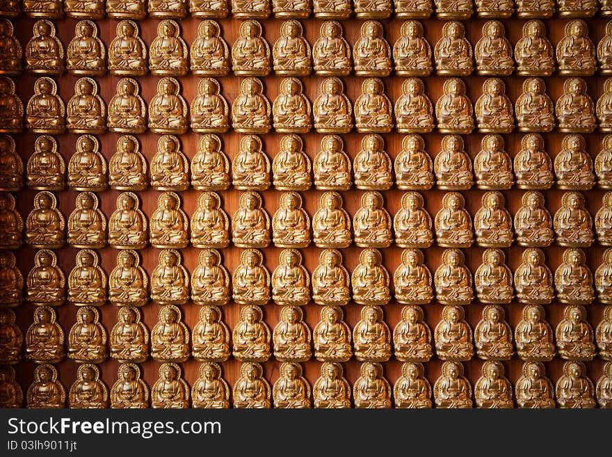 Golden buddha state on wooden floor