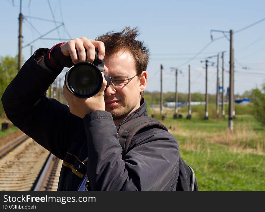 Working young photografer on sunny sprin day