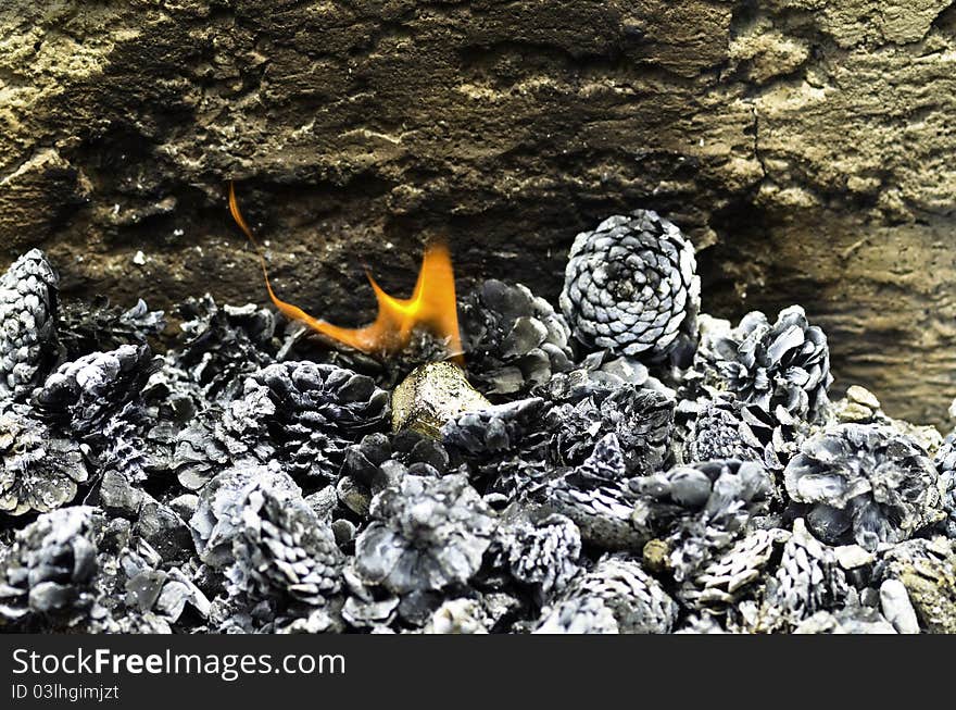 Several pine cones burning with a flame in the middle. Several pine cones burning with a flame in the middle