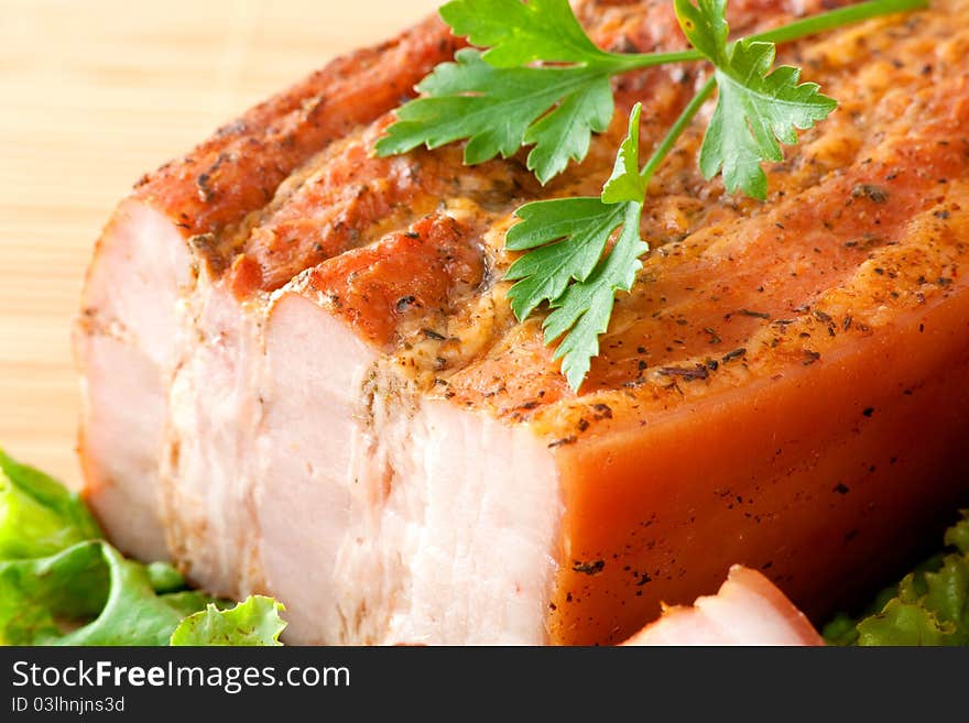 Smoked pork arranged on cutting board with parsley