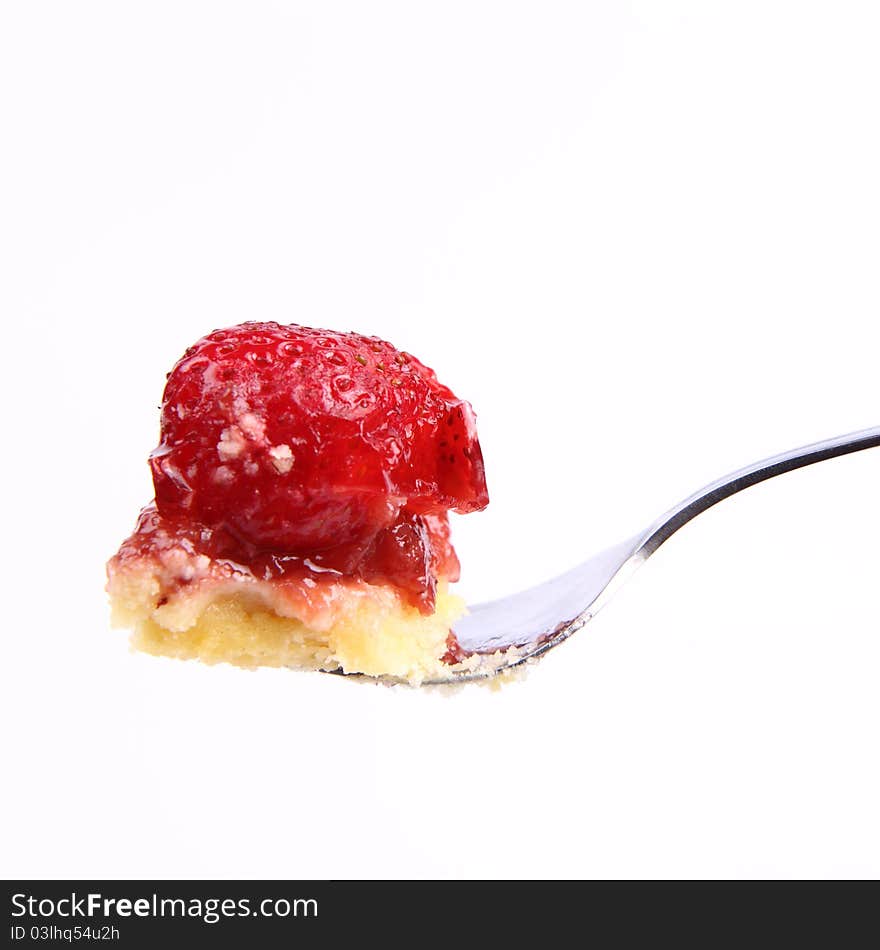 Piece of Strawberry Tart on a fork on a white background