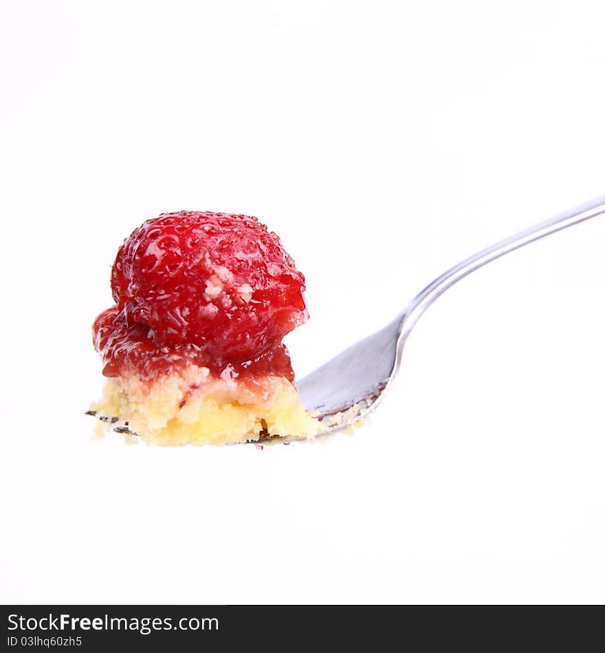 Piece of Strawberry Tart on a fork on a white background