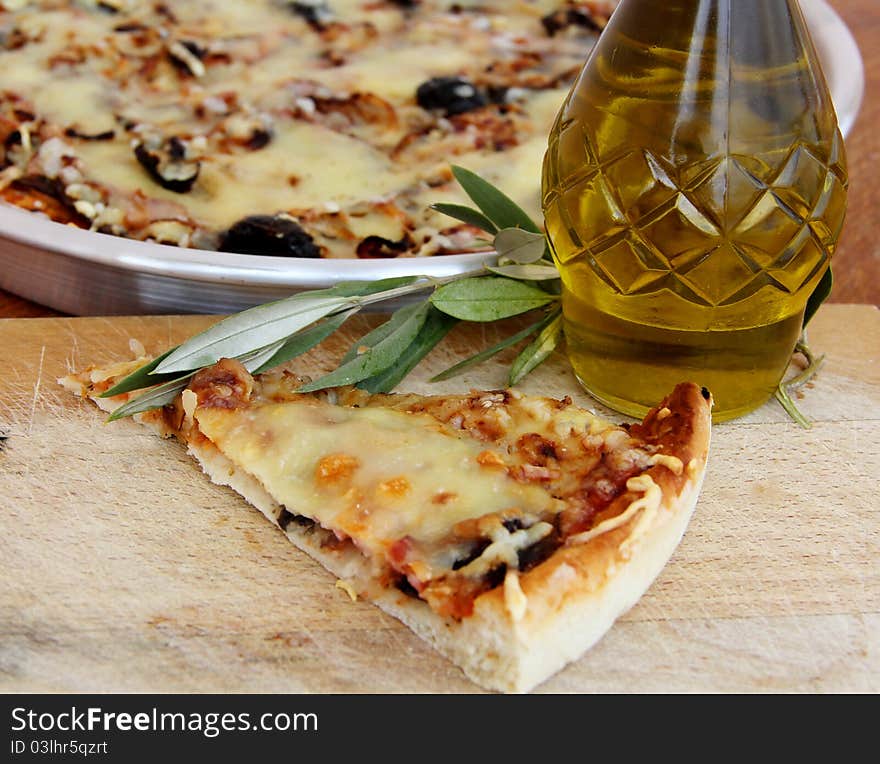 Close up of pizza with tomatoes, cheese, black olives and peppers.