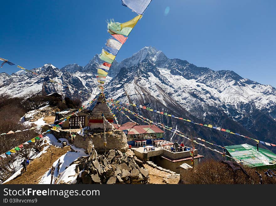 Scenic Himalayan view from Mong showing prayer flags at the crest of the pass. Scenic Himalayan view from Mong showing prayer flags at the crest of the pass