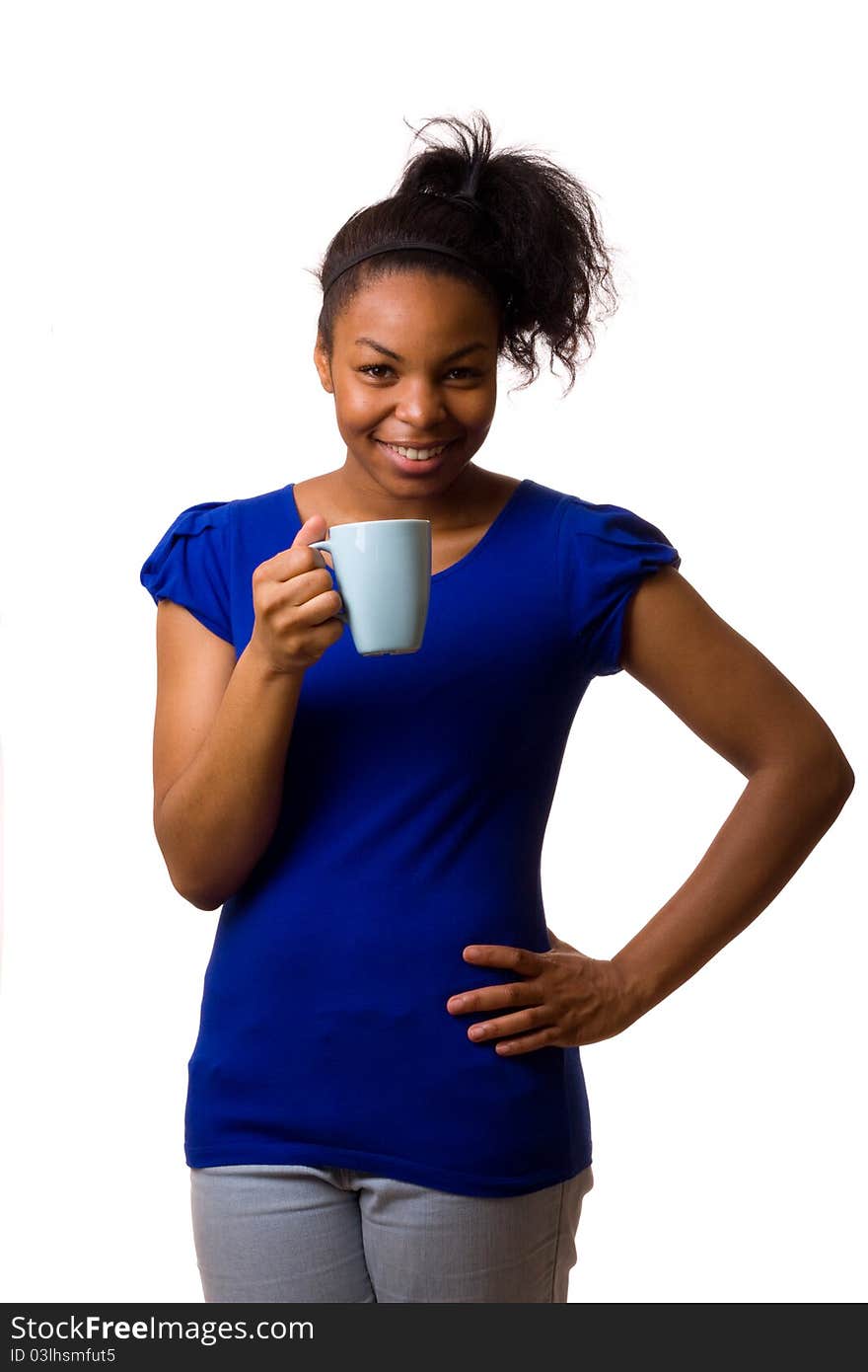 A young woman holding a mug of coffee. A young woman holding a mug of coffee.