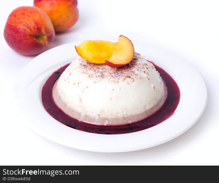 Panna-cotta with peach on white background