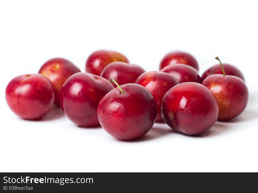 Sweet red plums isolated on white