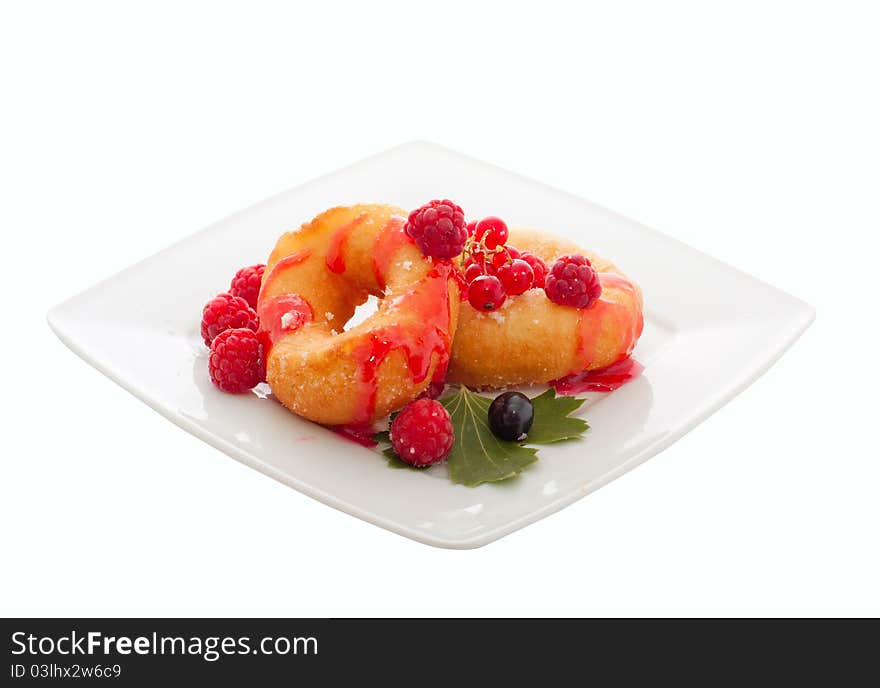 Donuts with fresh berries and jam over white plate. Donuts with fresh berries and jam over white plate