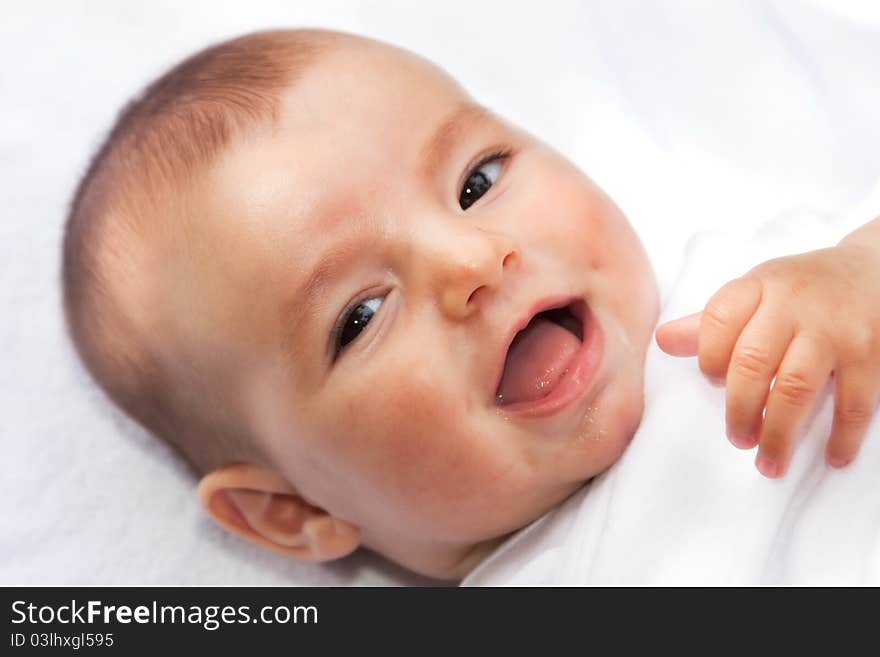 Closeup portrait of cute smiling baby boy