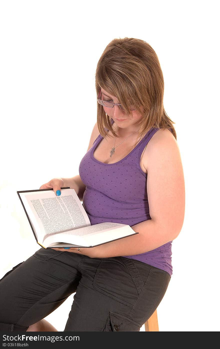 Young teenager, sitting on a chair, holding a book in her hands and reading
for white background. Young teenager, sitting on a chair, holding a book in her hands and reading
for white background.