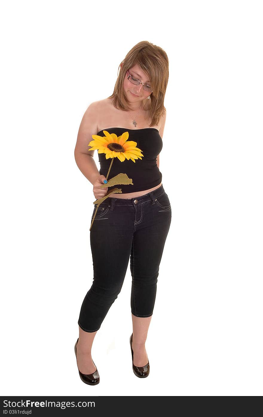 Teen holding sunflower.