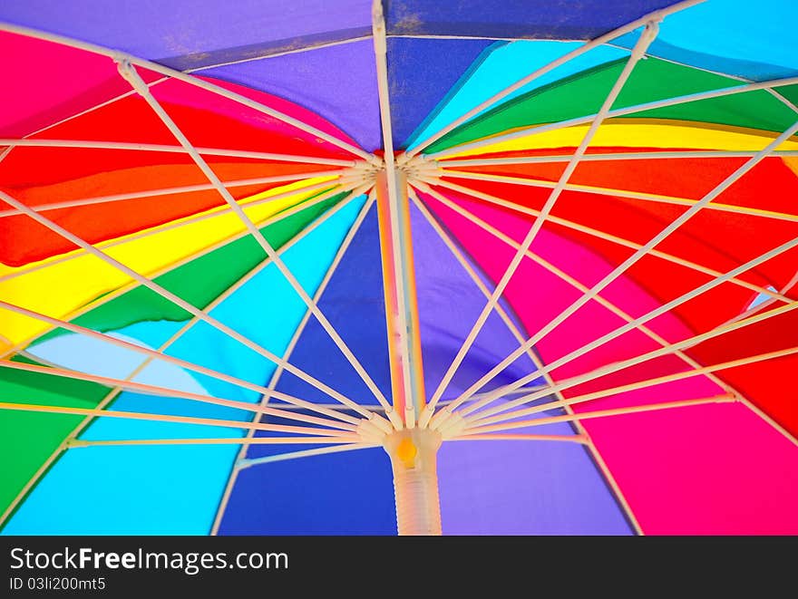 Underside of a rainbow colored beach umbrella