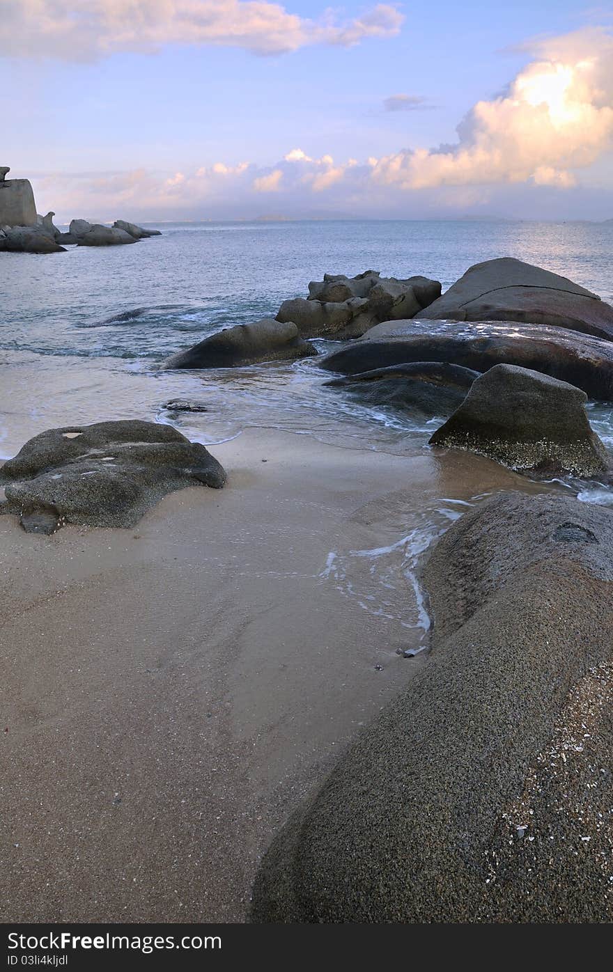 Rocky sea coast under sunset cloud, shown as featured physiognomy and landscape. Rocky sea coast under sunset cloud, shown as featured physiognomy and landscape.