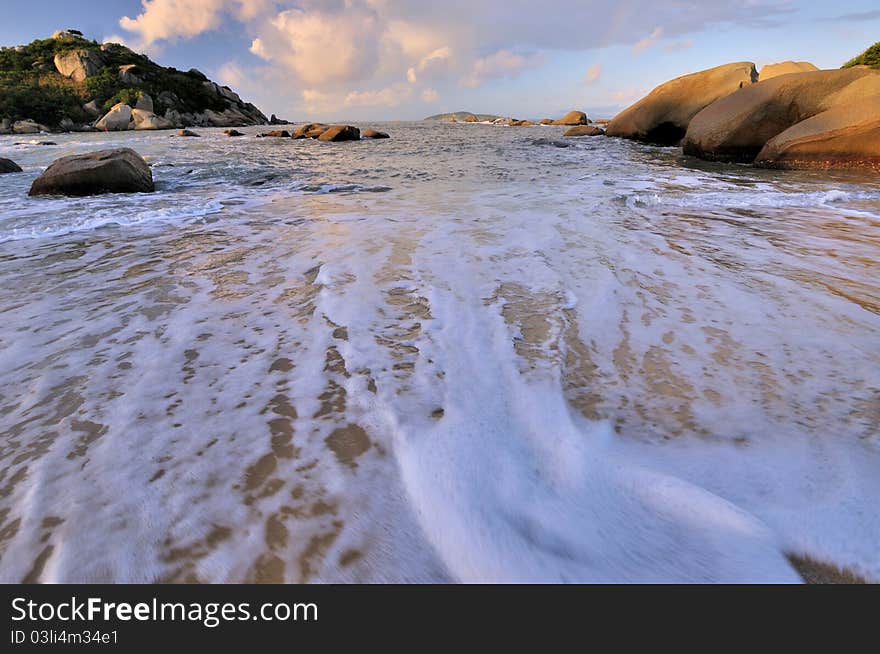 White water foam on sea beach, under sunrise lighting, shown as beach landscape and sunrise featured view. White water foam on sea beach, under sunrise lighting, shown as beach landscape and sunrise featured view.