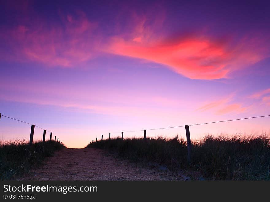 Path in the sand dunes at sunset