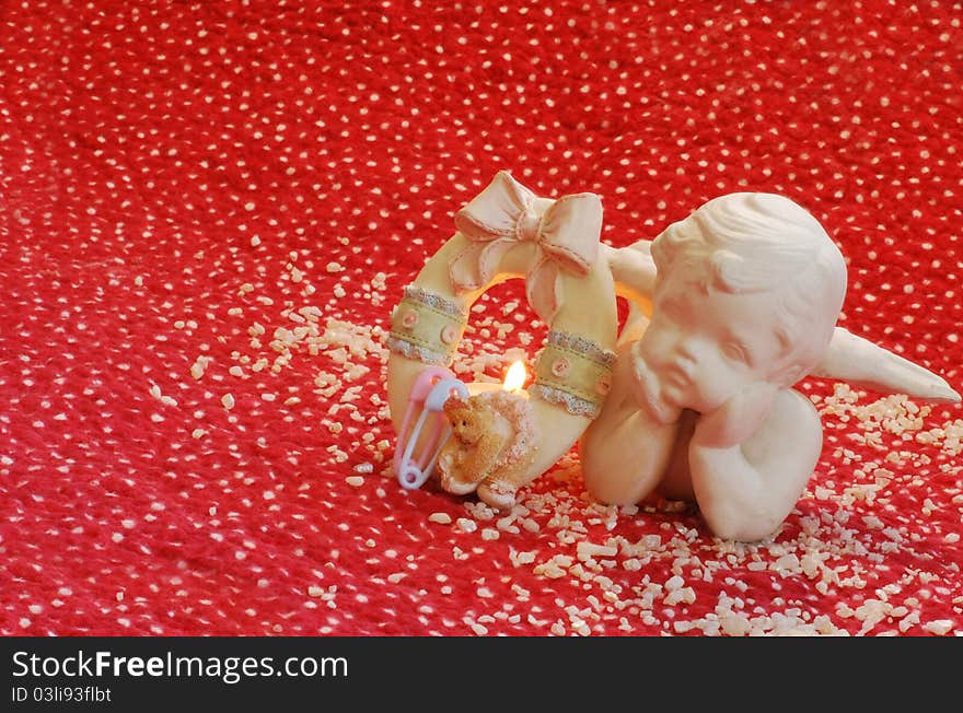 Birth announcement with angle on red and white quilt