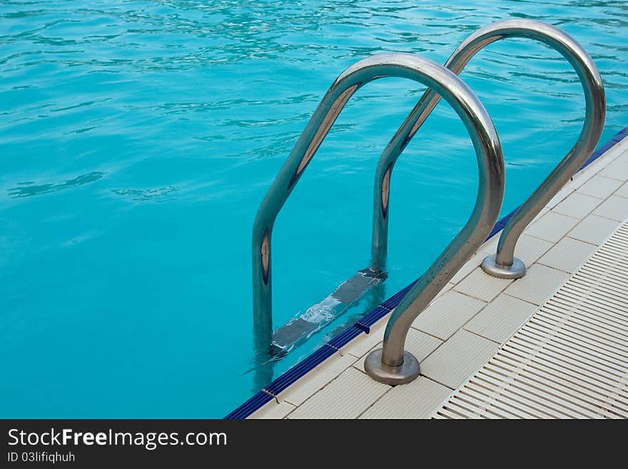 Log in outdoor pool with stairs and handrails