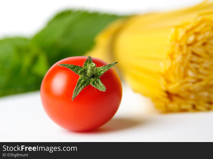 An image of a red tomato and pasta