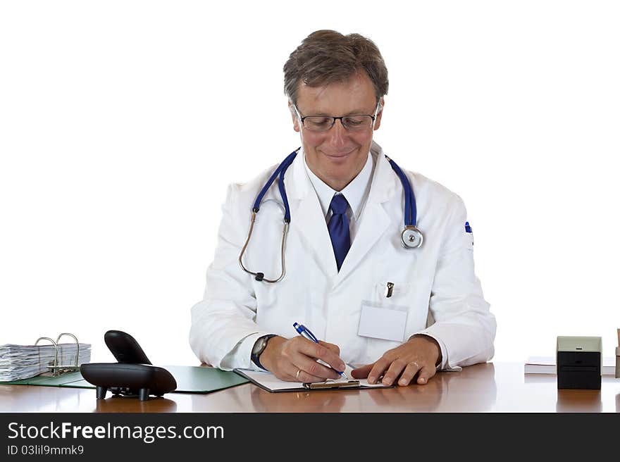 Trustful aged doctor writes down prescription smiling. Isolated on white background.