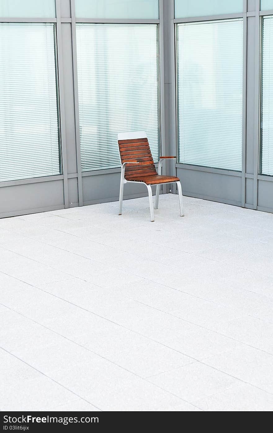 Single wooden chair in a bright empty room. Single wooden chair in a bright empty room.