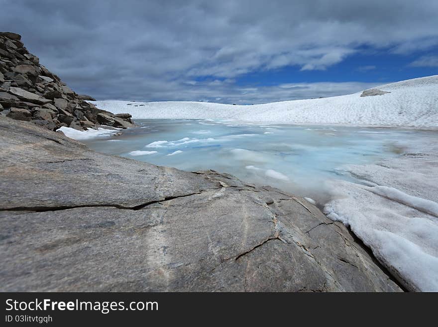 Small icy mountain lakes after a frozen night during summer. Small icy mountain lakes after a frozen night during summer