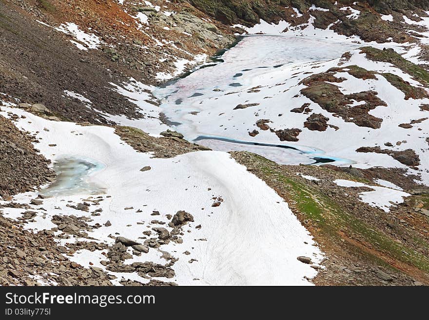 Small icy mountain lakes after a frozen night during summer. Small icy mountain lakes after a frozen night during summer