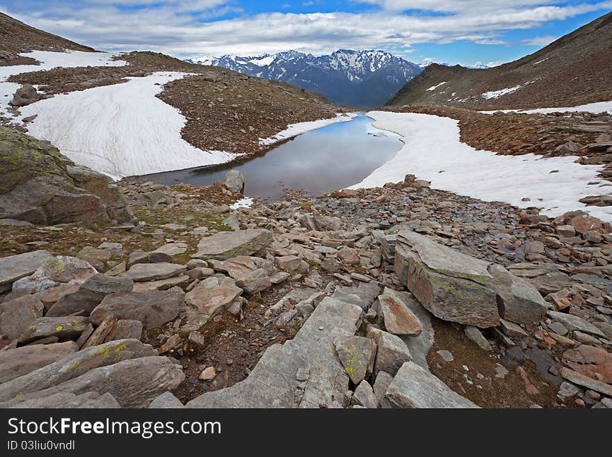 Small icy mountain lakes after a frozen night during summer. Small icy mountain lakes after a frozen night during summer