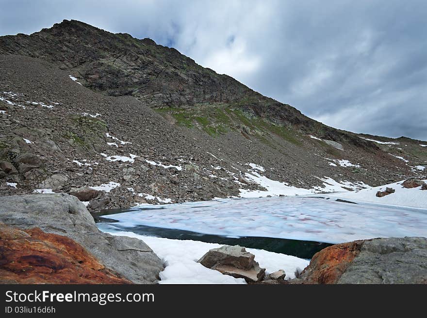 Small icy mountain lakes after a frozen night during summer. Small icy mountain lakes after a frozen night during summer