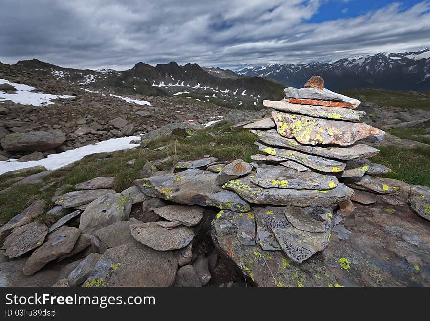 Stone signs for hikers and trekkers at 2.700 meters on the sea-level. Italian Alps