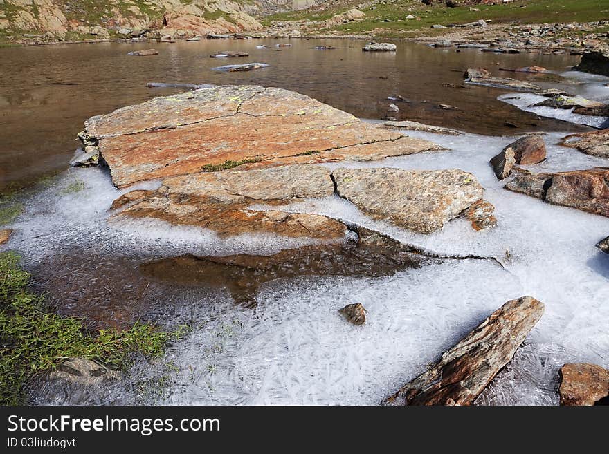 Small icy mountain lakes after a frozen night during summer. Small icy mountain lakes after a frozen night during summer