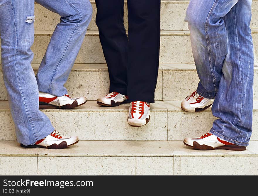 Men’s feet in sneakers standing on the stairs. Men’s feet in sneakers standing on the stairs