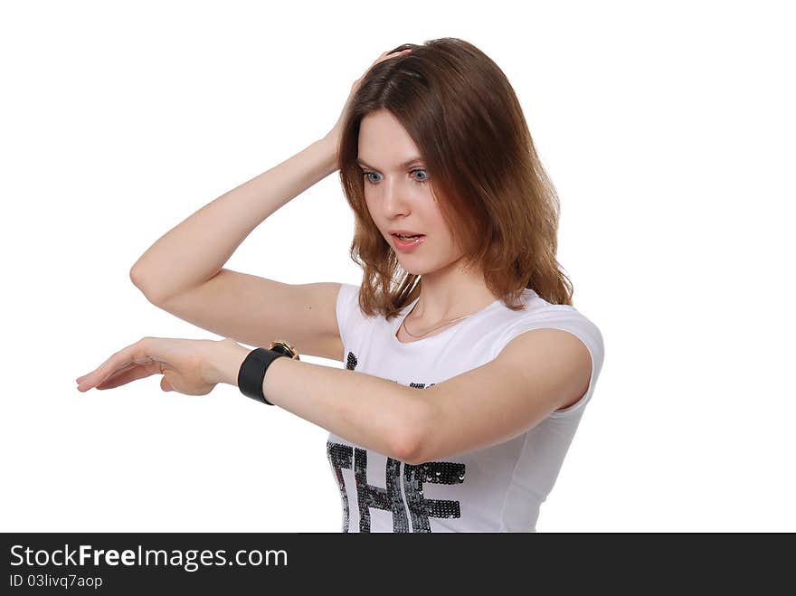 The girl looks at the watch isolated on white background