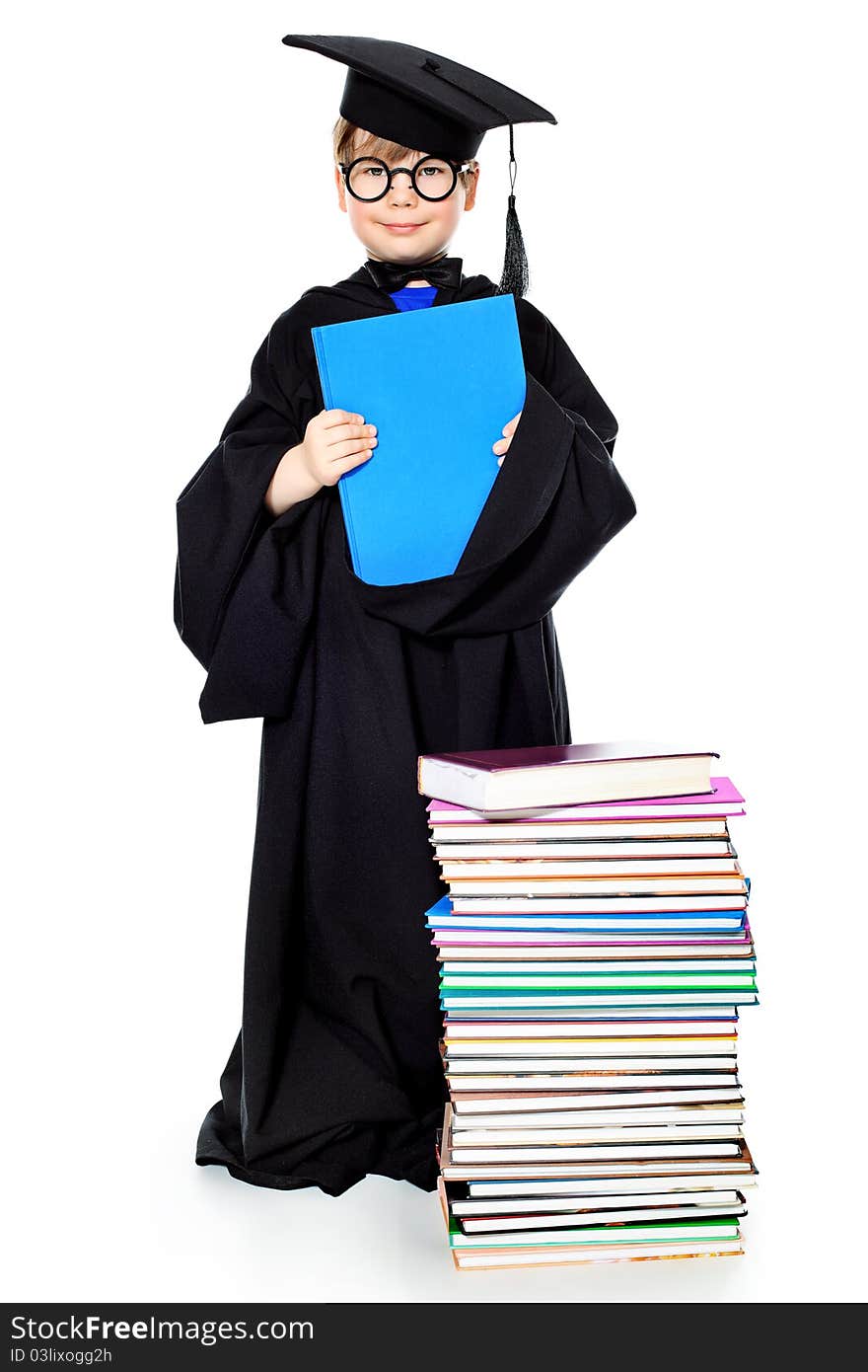 Cute little boy in a graduation gown. Isolated over white. Cute little boy in a graduation gown. Isolated over white.