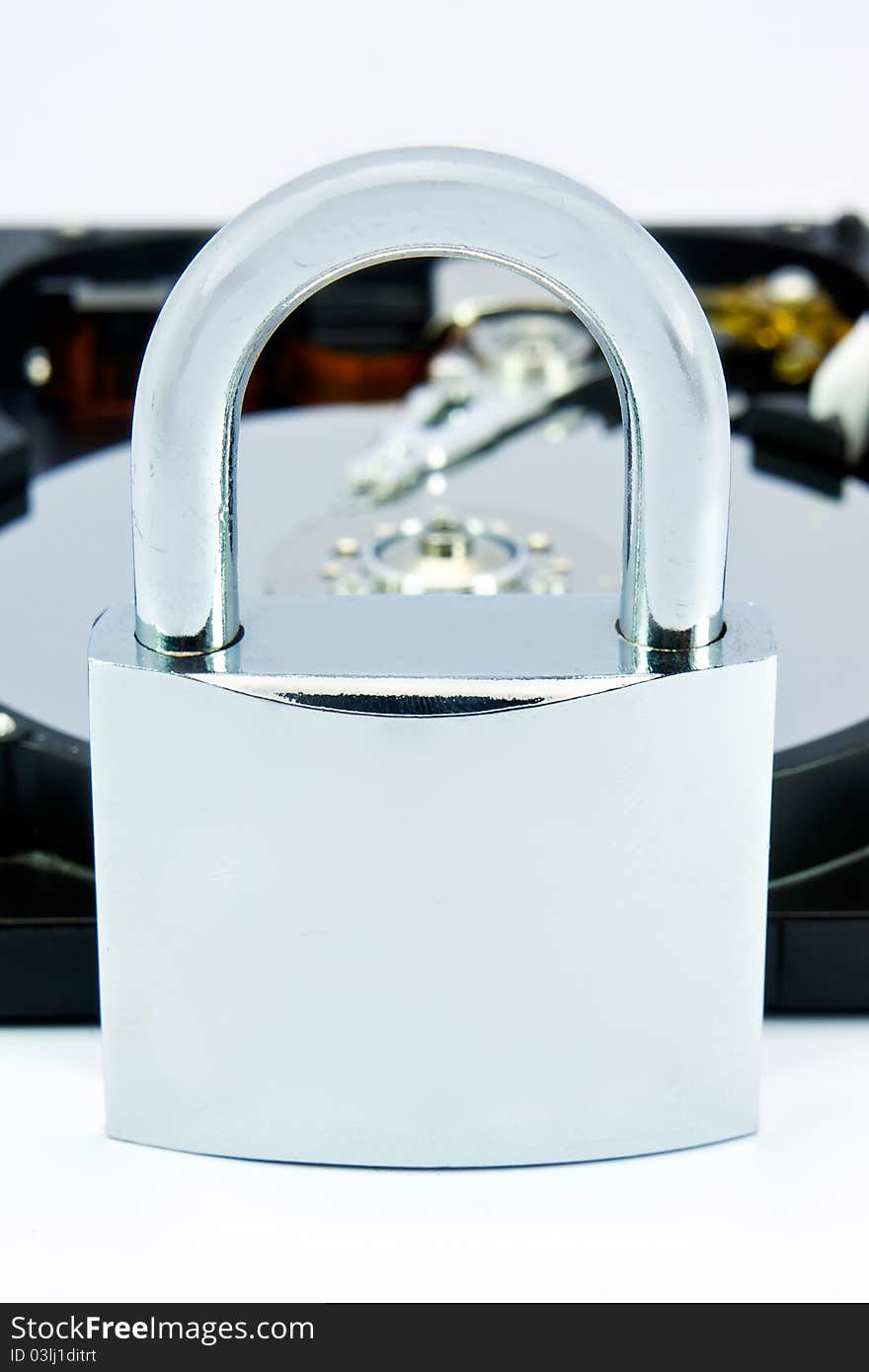 Opened computer hard disk locked with a padlock. Opened computer hard disk locked with a padlock