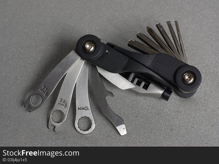 Black multifunctional bike tool on grey. Black multifunctional bike tool on grey