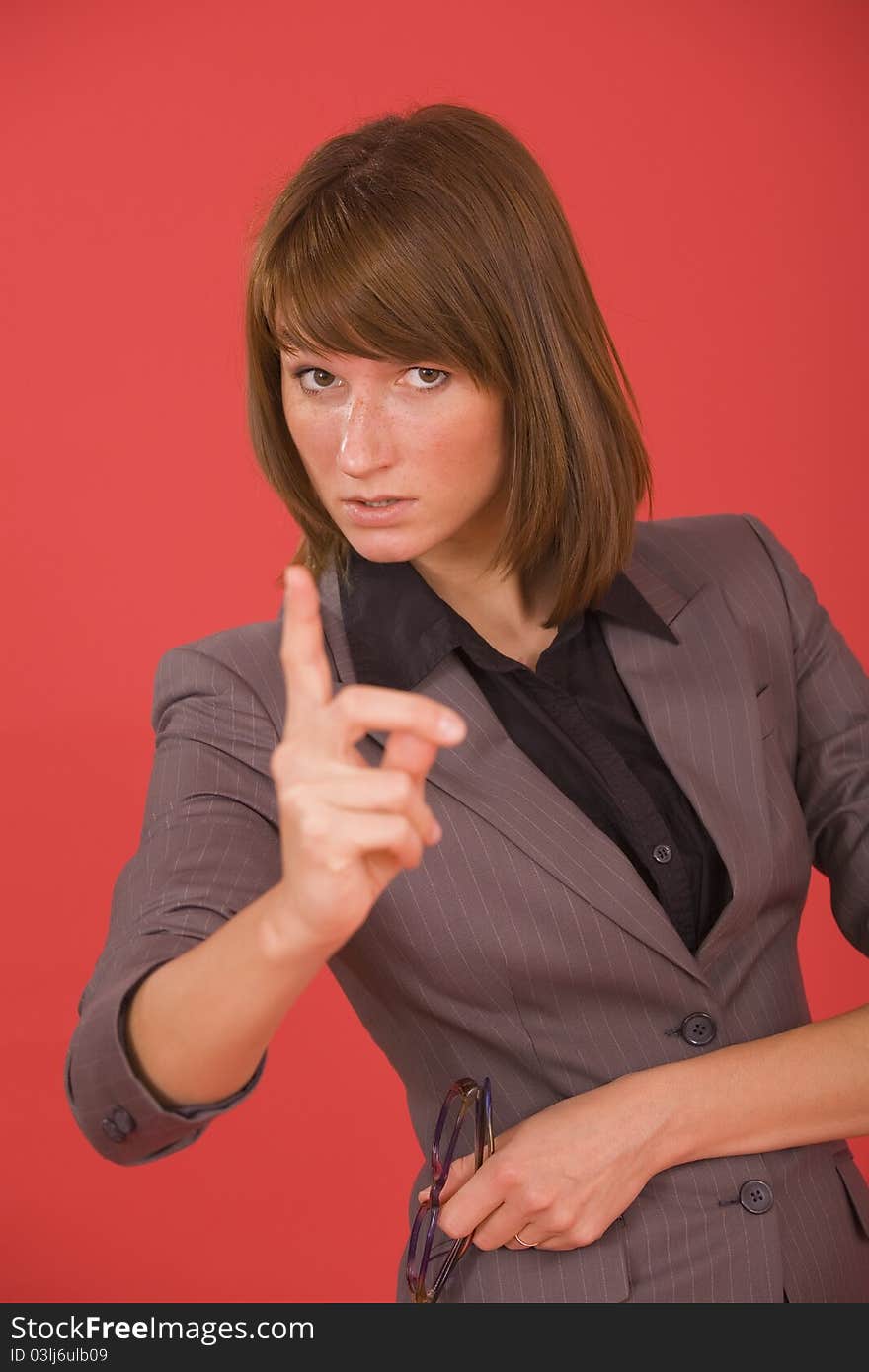 Business woman pointing with finger over red background