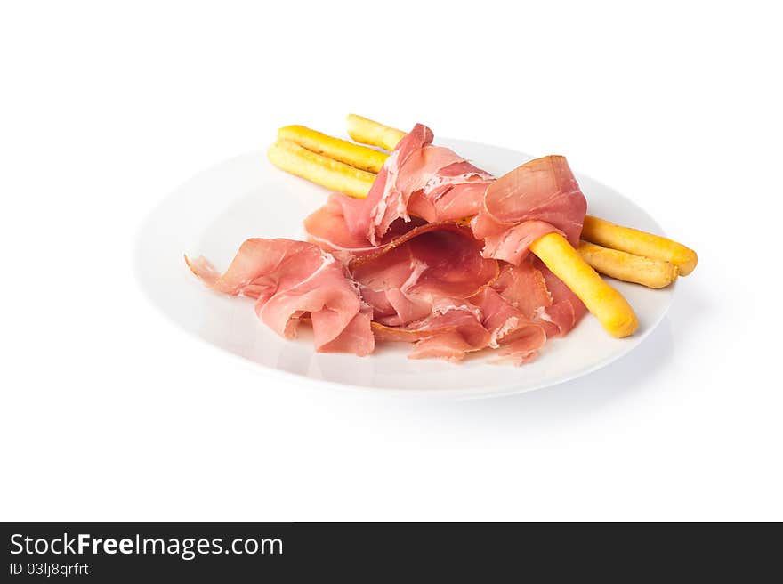 White plate with slices of Italian ham from Parma. White plate with slices of Italian ham from Parma