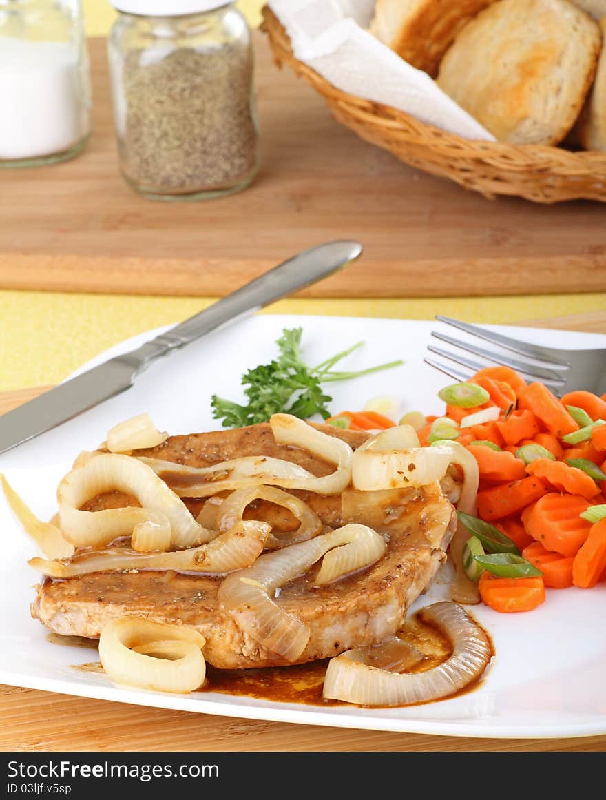 Pork loin dinner with onions and carrots